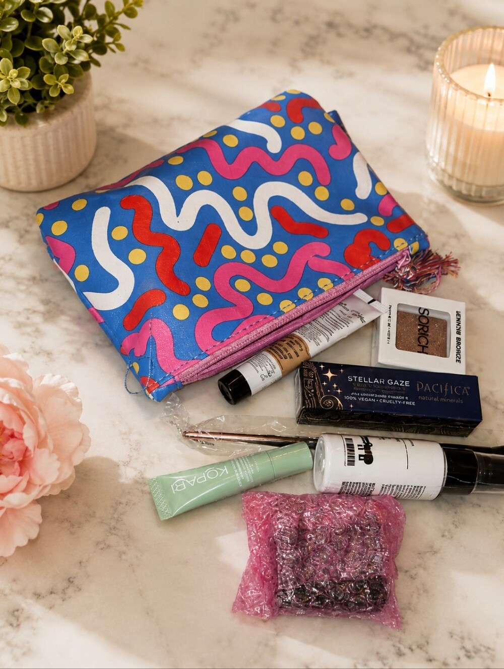 Colorful Patterned Makeup Bag with Assorted Beauty Products
